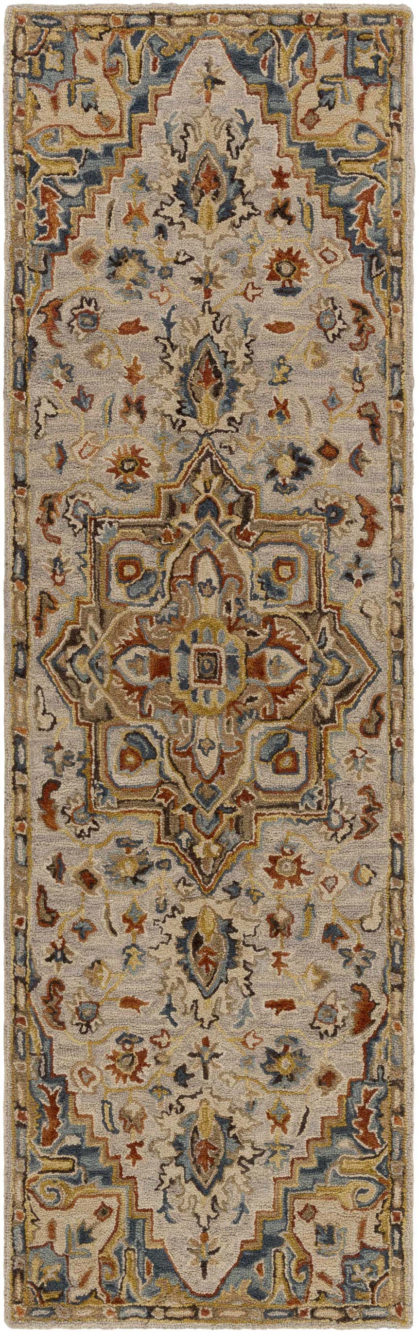 Close-up of the Birtley Area Rug. Hand-tufted wool rug in slate, blue, rust, and tan with a traditional Oriental-inspired design. Design-Runner-268