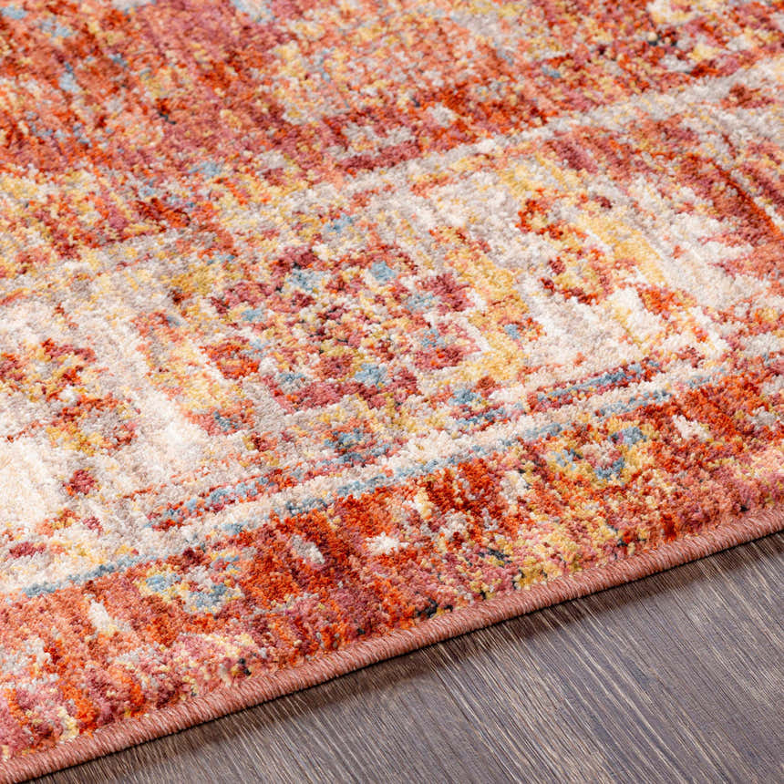 Close up of the Bluewell Area Rug, featuring brick red, charcoal, and light beige colors. Texture