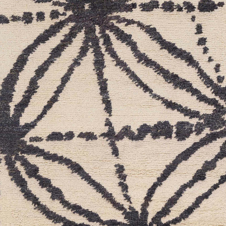Close-up of the Bonnyman Jute Carpet showing its ivory background and black geometric pattern, hand woven texture. Swatch