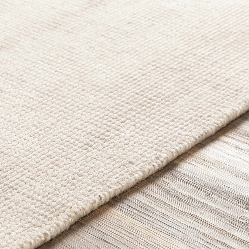 Close-up of the hand-loomed Bowstring Carpet. Cream and taupe viscose rug with a subtle, contemporary texture. Texture