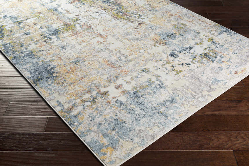 Close-up of the Bozeat Area Rug showing its charcoal, cream, olive, and rust contemporary design and soft texture. Corner