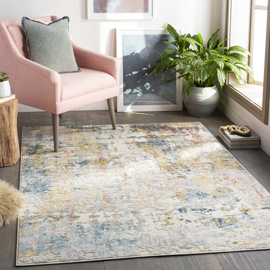 Living room scene with pink chair and Bozeat Area Rug in charcoal, cream, olive, and rust colors. Contemporary style. Roomscene-Rectangle