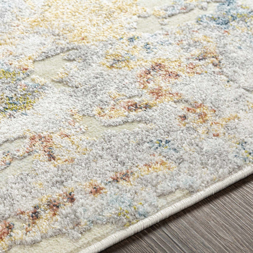 Close-up of the Bozeat Area Rug, a contemporary rug with charcoal, cream, rust, and olive tones. Machine woven texture. Texture