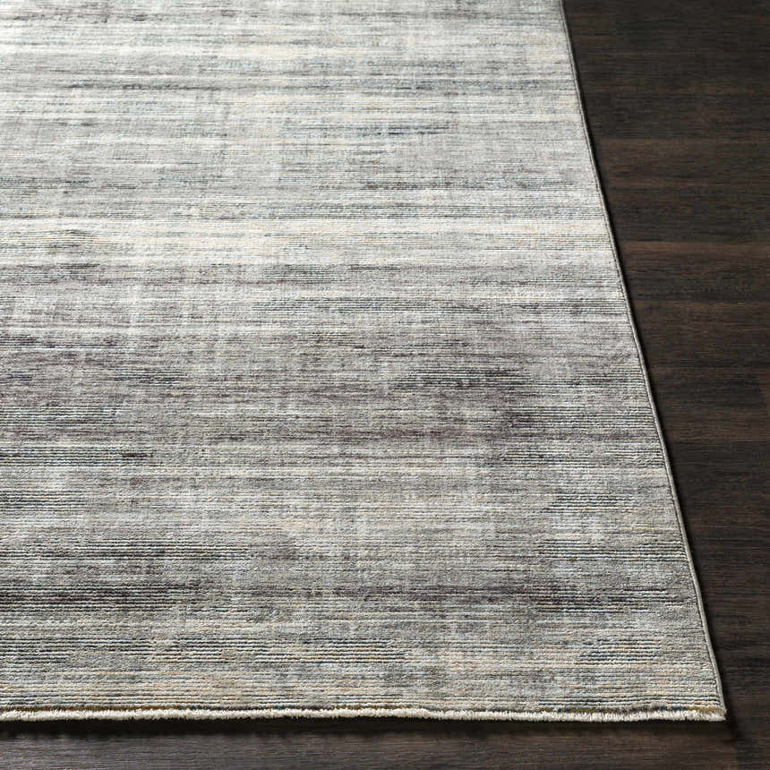 Braxton Carved Statement Area Rug in gray, ivory, and sage on a dark wood floor. Contemporary style. Front