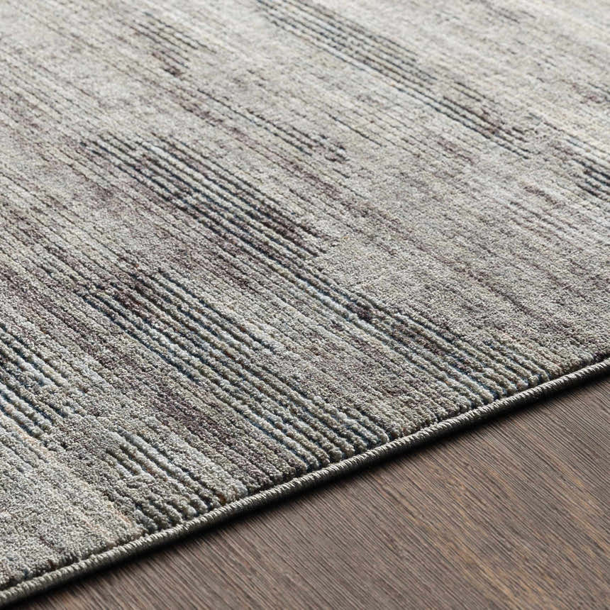 Close up of the Braxton Carved Statement Area Rug showing its carved texture and colors of gray, ivory and charcoal. Texture