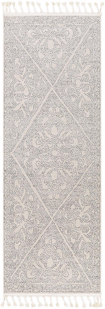 Close-up of the Birdwood Area Rug. Gray and charcoal bohemian pattern with tassels. Design-Runner-2710
