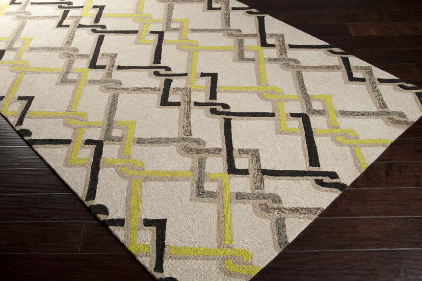Close-up of the Brilliant Area Rug with a contemporary geometric pattern in brown, beige, taupe, and light olive on dark wood flooring. Corner