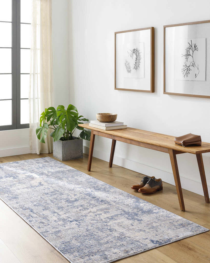 Entryway with Broxbourne Area Rug runner in blue, cream, and taupe. Bench with shoes, plant, and framed art. Contemporary style. Roomscene-Runner