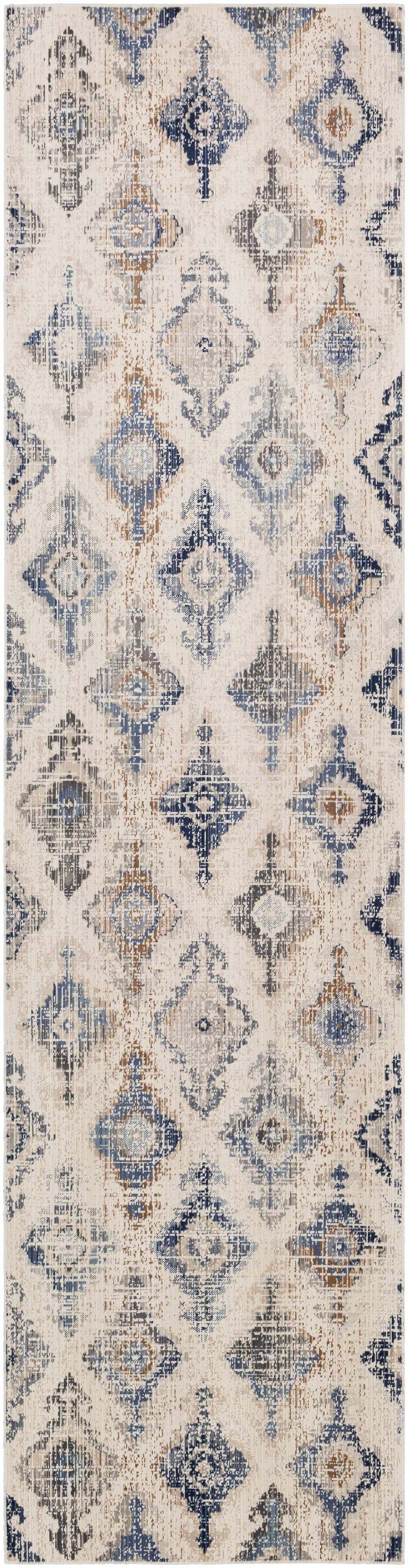 Close-up of the Buckner Blue Ikat Rug, a machine-woven polypropylene rug with a bohemian-inspired diamond pattern. Design-Runner-295
