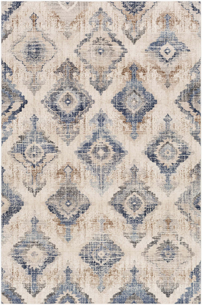 Close-up of the Buckner Blue Ikat Rug, featuring a diamond pattern in denim, navy, gray, and brown on a white background. Design-Rectangle-5710