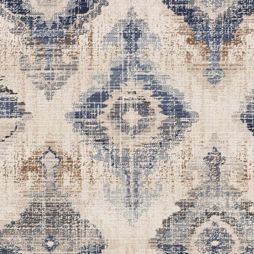 Close-up of the Buckner Blue Ikat Rug, featuring a traditional pattern in denim, navy, brown, gray, and white hues. Swatch