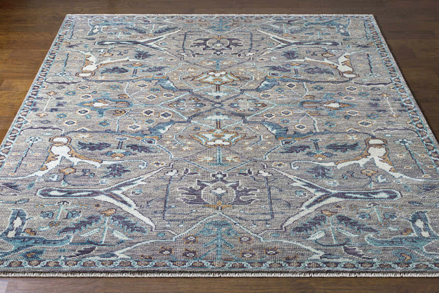 Detailed view of the hand-knotted Bugasan Area Rug. Gray, teal, plum, and brown tones. Bohemian style. Front