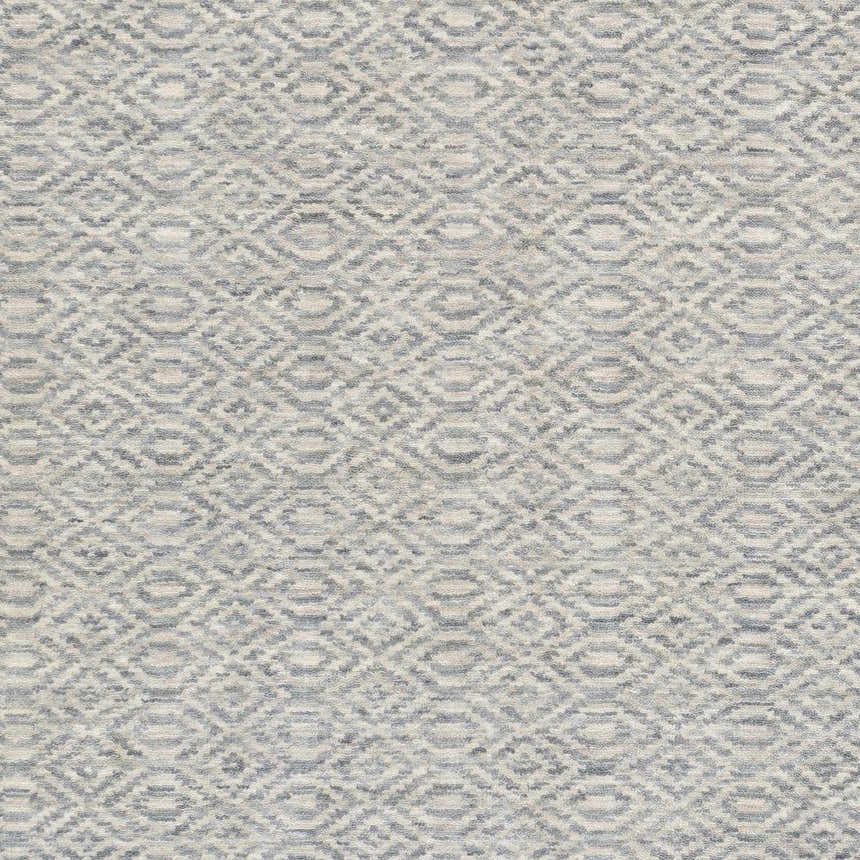 Close-up of the Bumpass Area Rug. Hand-knotted wool rug in light sage and medium gray with a contemporary geometric pattern. Swatch