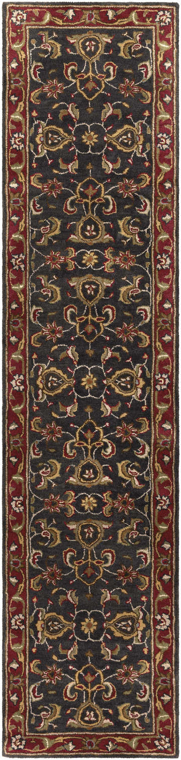 Close-up of the Bunola Area Rug. Hand-tufted wool rug with a traditional Persian-inspired floral pattern in amber, red, and navy. Design-Runner-310