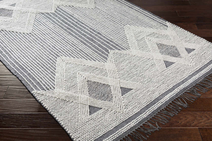 Close-up of the Aldbourne Gray Tassel Flatweave Wool Rug, showcasing its geometric pattern, tassels, and woven texture. Corner