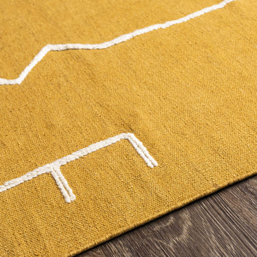 Close-up of a yellow Bushra Area Rug with a white geometric design, hand woven texture. Texture