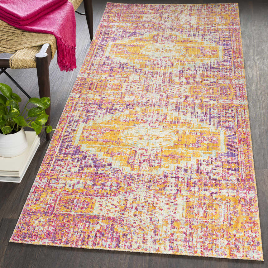 Farmhouse style room with a Callahan Area Rug in burgundy, lavender, red, white, and yellow on a dark wood floor. Roomscene-Rectangle