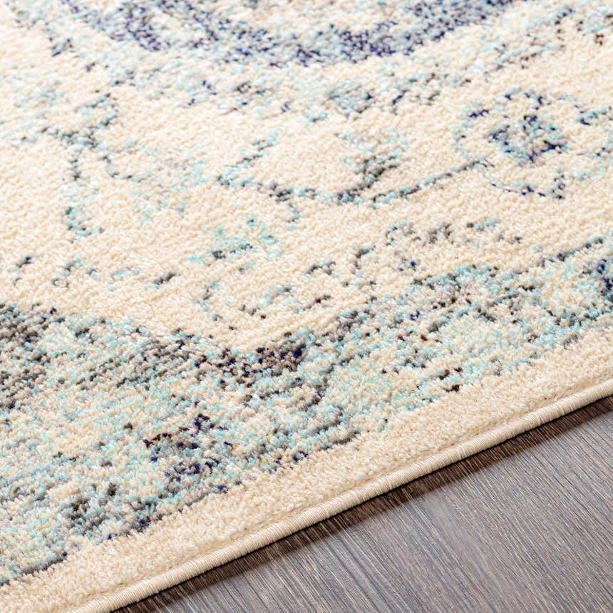 Close-up of the Calpine Area Carpet featuring a traditional ivory, blue, and gray oriental design. Texture