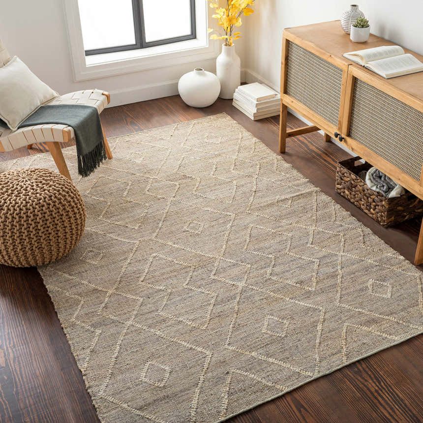 Bohemian living room with Carine Jute Area Rug in beige, chair, pouf, wood cabinet, and dark wood floors. Roomscene-Rectangle
