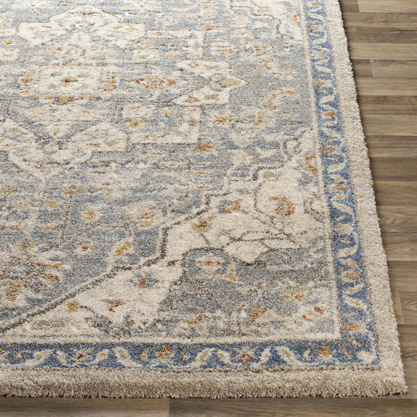 Close up of Chesnee Thick Luxe Rug showing its traditional blue, gold, and white floral pattern and plush texture. Front