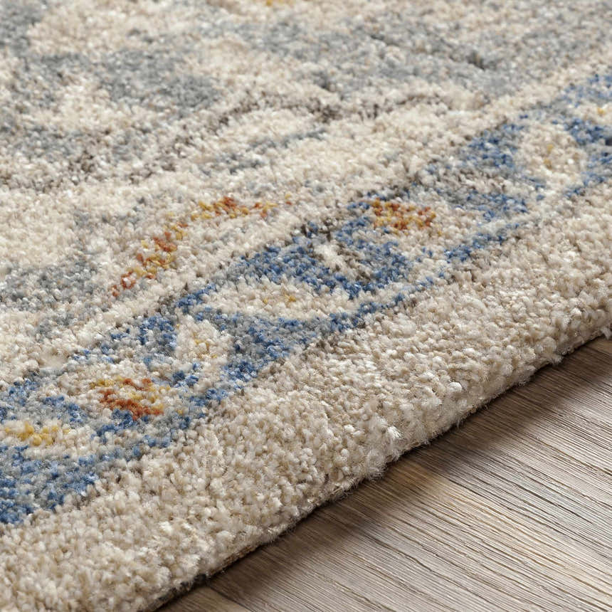 Close-up of the Chesnee Thick Luxe Rug, showing its plush texture and bohemian pattern in aqua, blue, and metallic gold. Texture