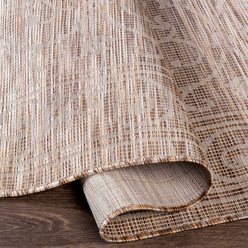 Close-up of the Coolville Brown Flatweave Area Carpet showing its woven texture and neutral brown, cream, and tan colors. Fold