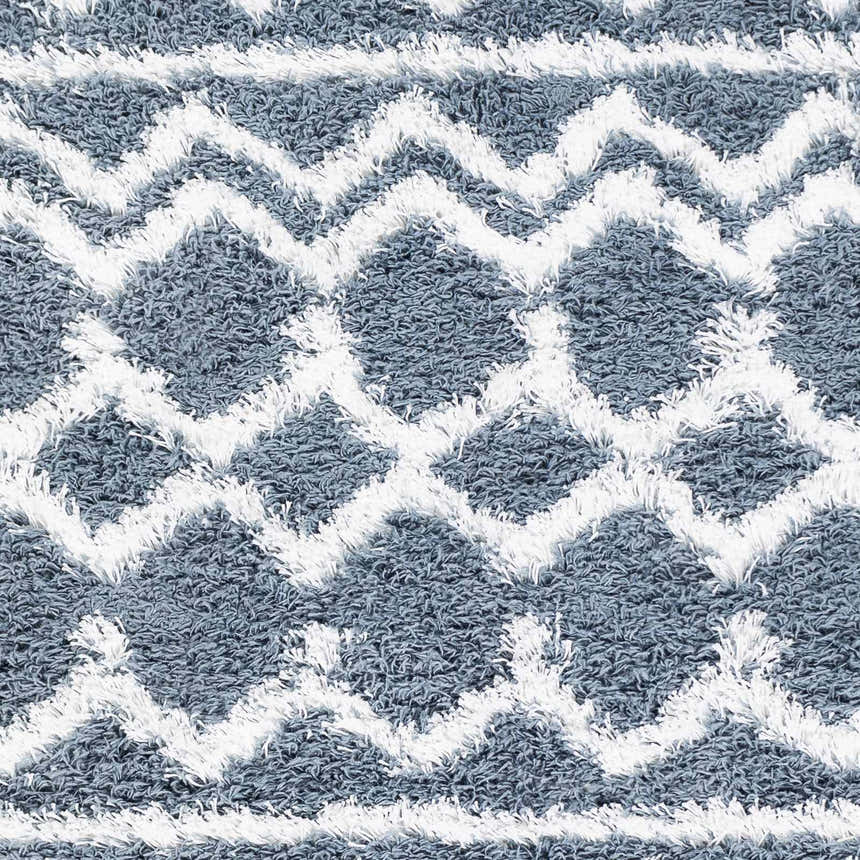Close-up of the denim and white Camp Shag Area Rug, featuring a geometric diamond pattern and soft, shaggy texture. Swatch