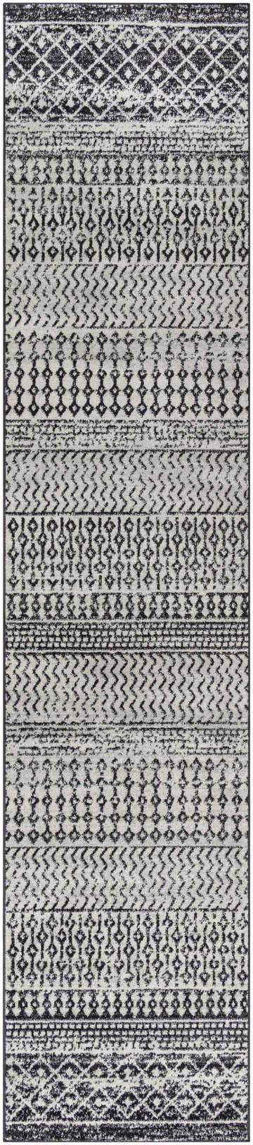 Close-up of the Constantin Area Rug, a machine-woven runner with a black and gray bohemian-inspired geometric pattern. Design-Runner-2712