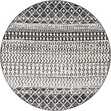 Close-up of a round Constantin Area Rug with black and white bohemian-inspired geometric patterns. Design-Round-6