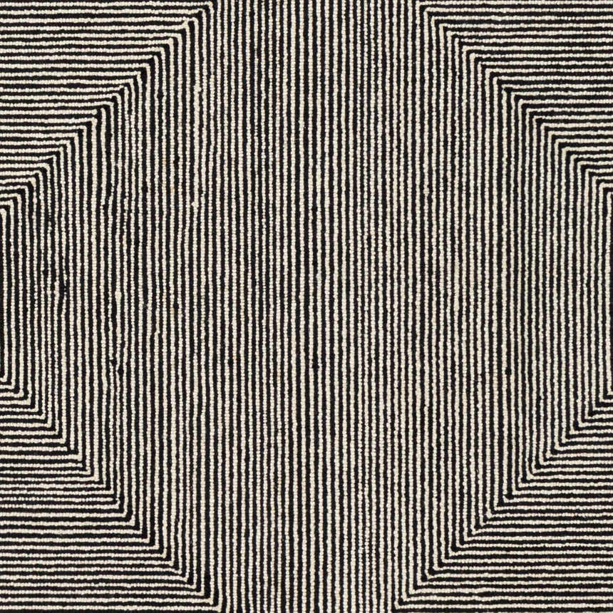 Close-up of the hand-tufted Conshohocken Area Rug. Black and cream wool rug with a geometric Moroccan-inspired pattern. Swatch