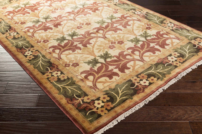 Close-up of the hand-knotted Corbridge Area Carpet. Wool rug features a traditional floral pattern in black, burgundy, and olive. Corner
