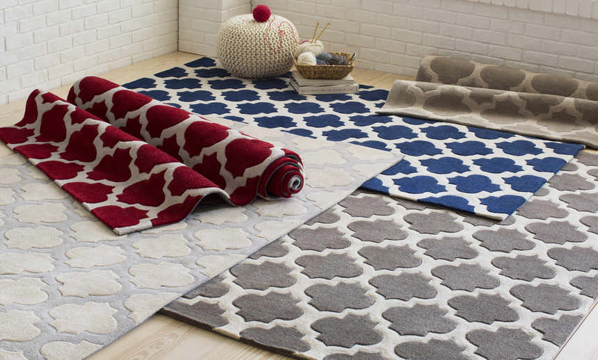 Highspire Area Rug in light gray, taupe, blue, and red. Contemporary quatrefoil pattern rugs in a bright room. Styleshot