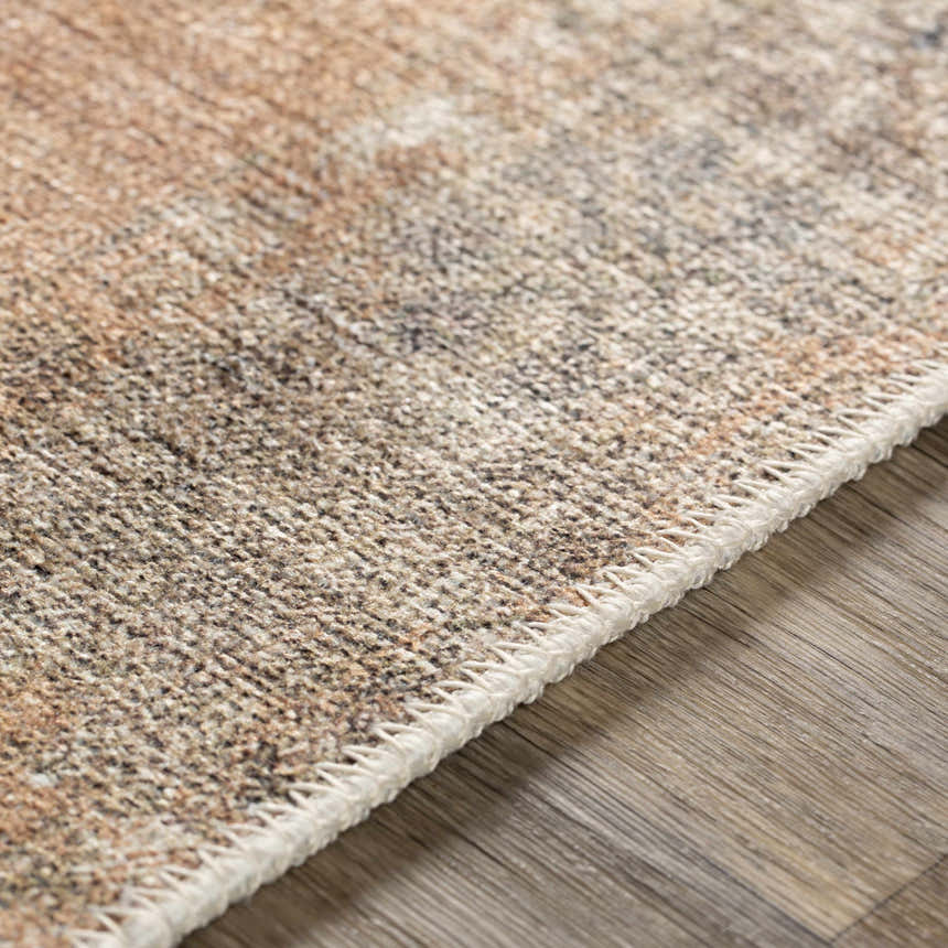 Close-up of the Carrabelle Peach Washable Area Rug showing the chenille-polyester texture and oriental-inspired pattern. Texture