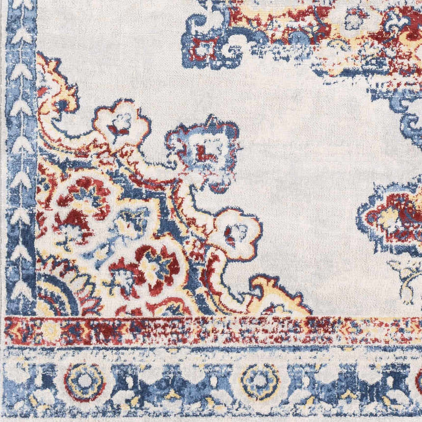 Close up of the Carron Area Rug showing its blue, red, and yellow traditional floral pattern. Swatch