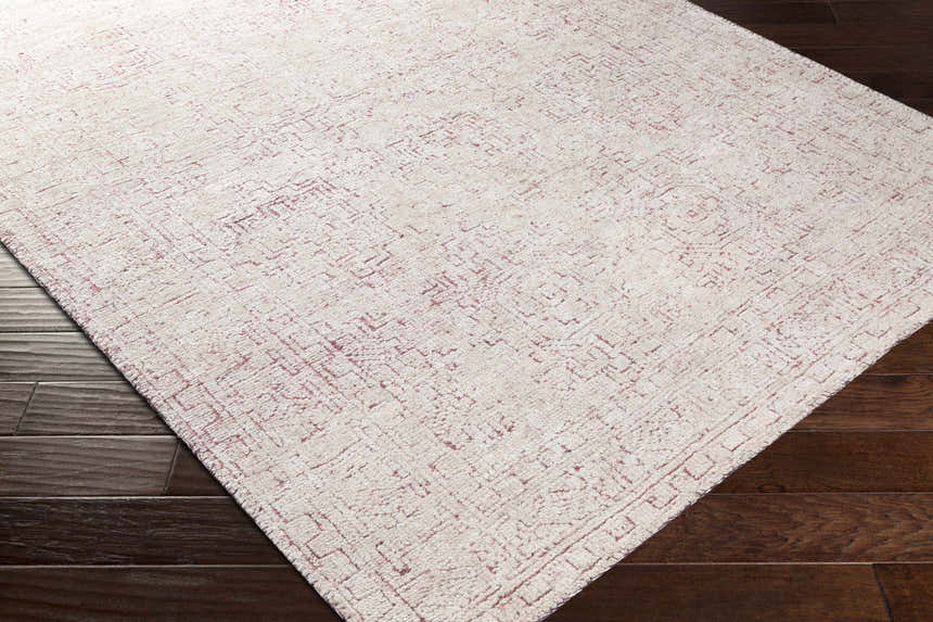 Close-up of the hand-knotted Cunderdin Carpet. Mauve and white viscose rug with a traditional geometric pattern. Corner