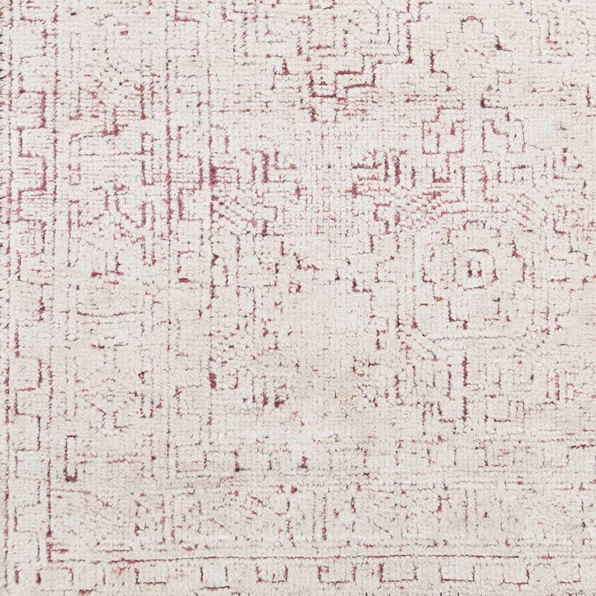 Close-up of the Cunderdin Carpet showing a hand-knotted, geometric pattern in mauve on a white, viscose pile. Swatch