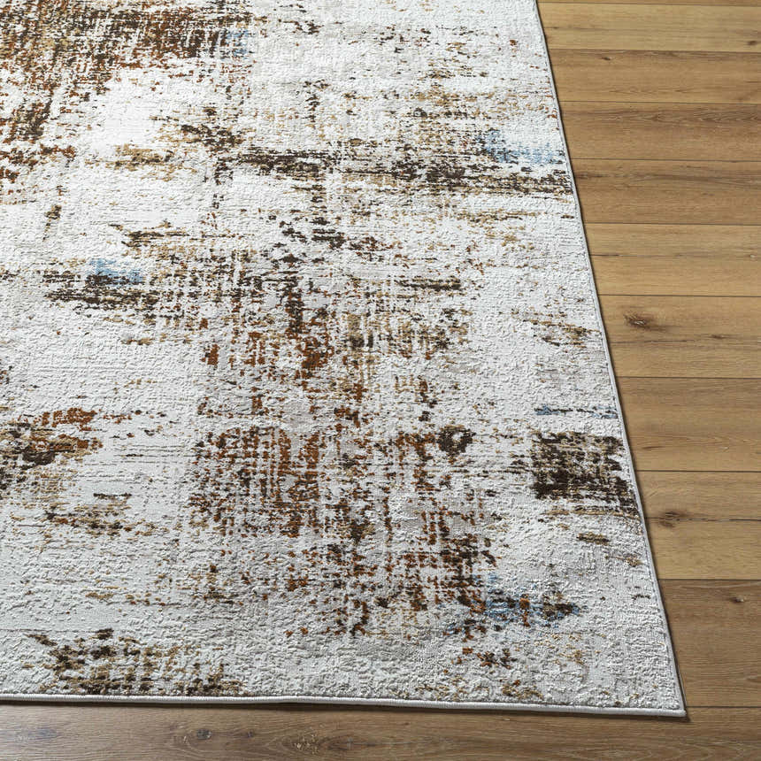 Close-up of the Utcha Area Rug showing its brown, taupe, and white abstract pattern and textured polypropylene material. Front