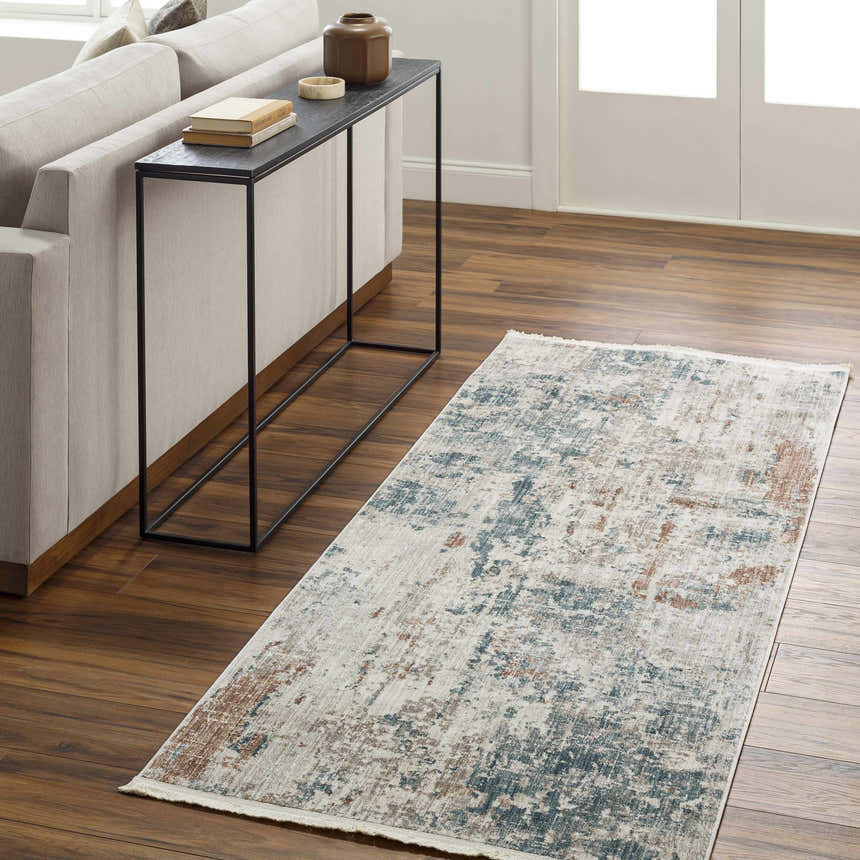 Living room scene with a charcoal, cream, and blue Danlugan Area Rug. Modern sofa and console table. Roomscene-Runner