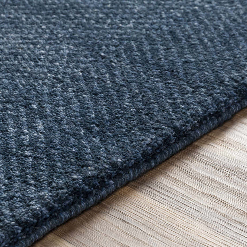 Close up of the hand knotted Dateland Area Rug in navy and pale blue. Wool and viscose blend. Texture