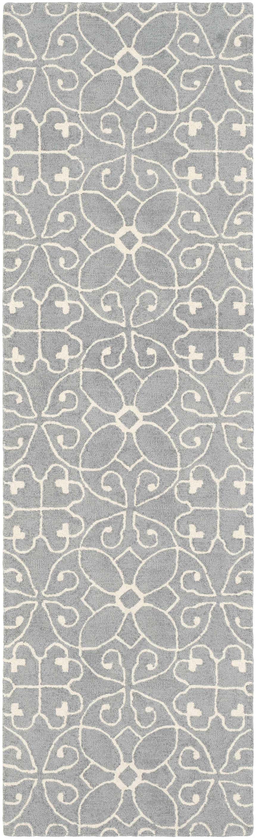 Close-up of Davie Area Rug, a hand-tufted wool runner with a slate blue background and ivory floral pattern. Design-Runner