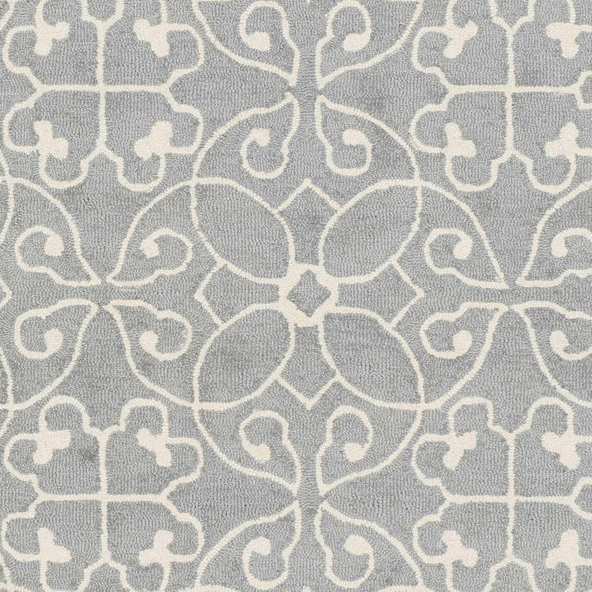 Close-up of the Davie Area Rug. Slate blue wool rug with an ivory traditional floral pattern. Hand-tufted texture. Swatch