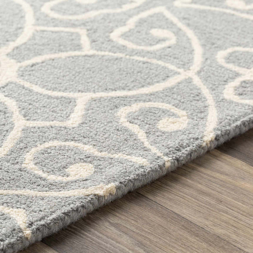 Close up of the Davie Area Rug, ivory and slate blue wool with a traditional floral pattern. Texture