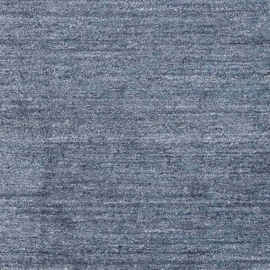 Close-up of the blue Davy Viscose Area Rug. Hand-loomed rug with a subtle striped texture. Swatch