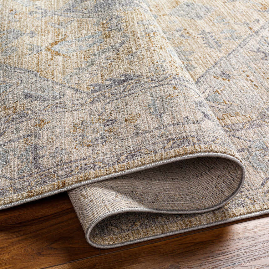 Close-up of Deena Thick Luxe Area Rug showing brown, charcoal, and sage tones on a hardwood floor. Fold
