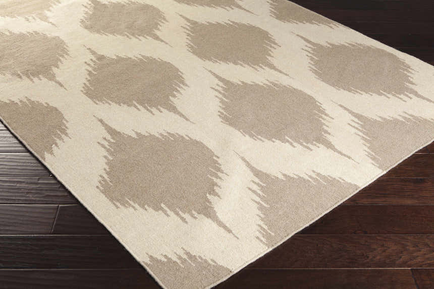Close-up of the hand woven Deshler Area Carpet. Light beige wool rug with a taupe, contemporary pattern. Corner