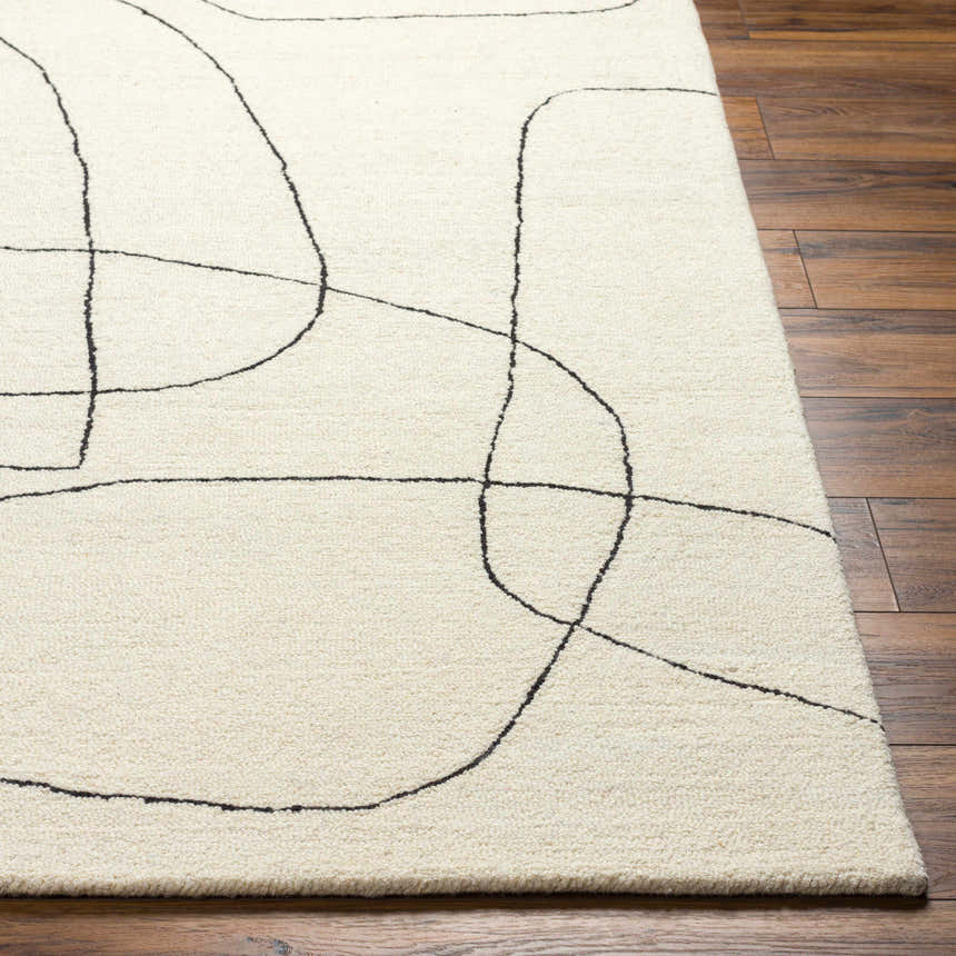 Close-up of Deniz Modern Off-White Wool Rug showing its abstract black line design and plush texture on a wood floor. Front