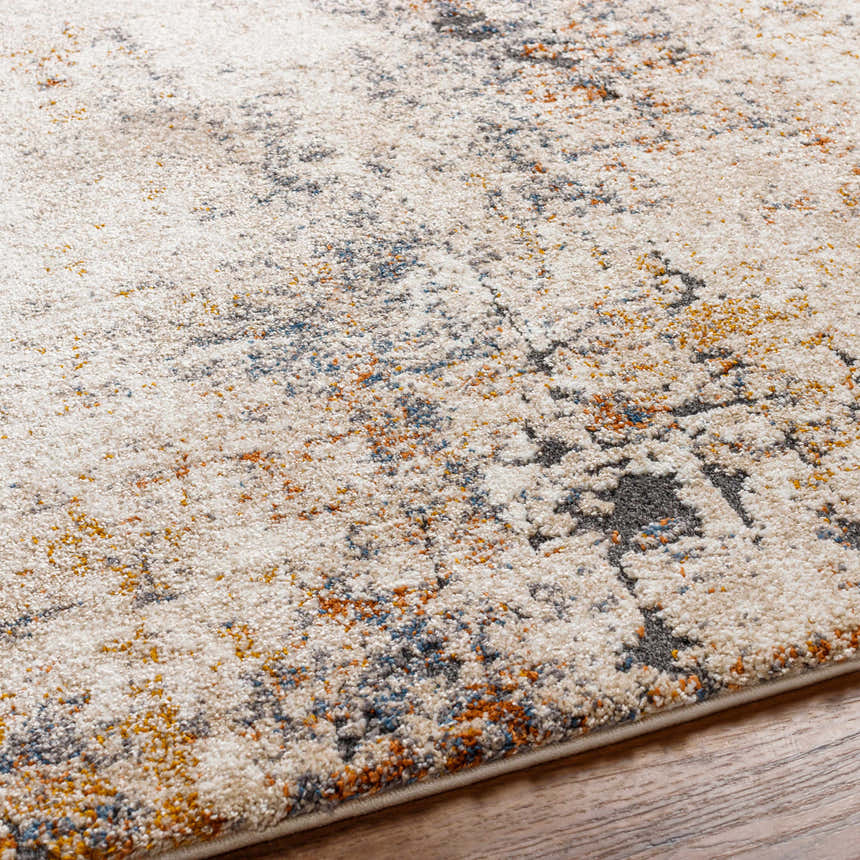 Close-up of the Donar Thick Luxe Rug. Features a textured, abstract design in ivory, beige, blue, and charcoal tones. Texture