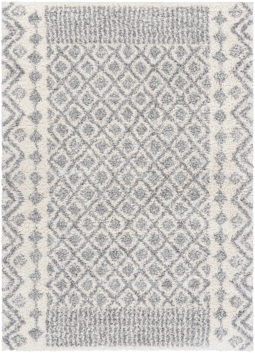 Close-up of the Downton Area Rug. Features a gray and white geometric diamond pattern and soft, textured pile. Design-Rectangle-5373