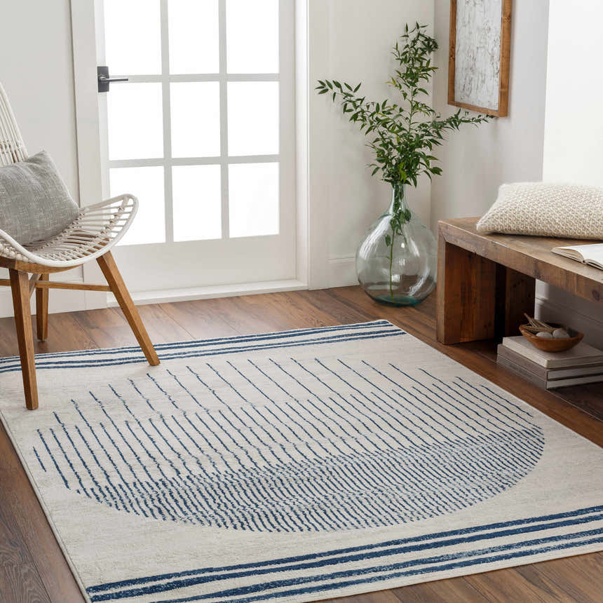 Entryway with a Duri Area Rug in admiral blue and natural gray, styled with a bench and chair. Roomscene-Rectangle