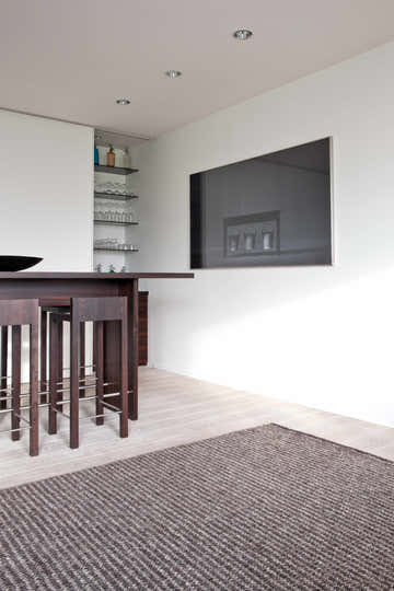 Modern kitchen with dark wood bar and gray Edisto Area Rug. Roomscene-Rectangle